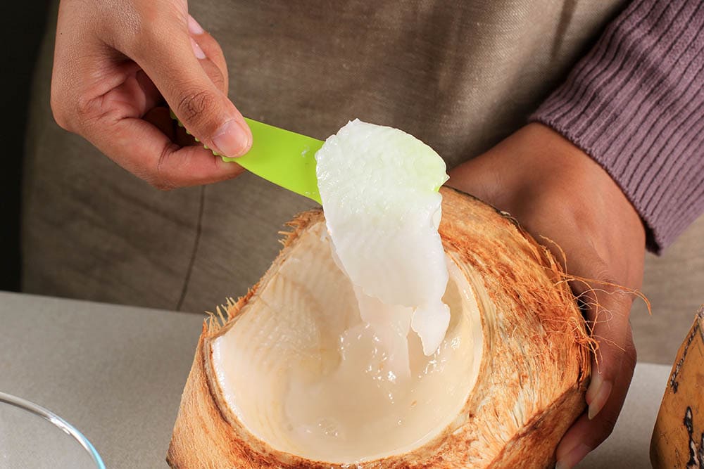 Hand Shredded Young Coconut Flesh to the Bowl